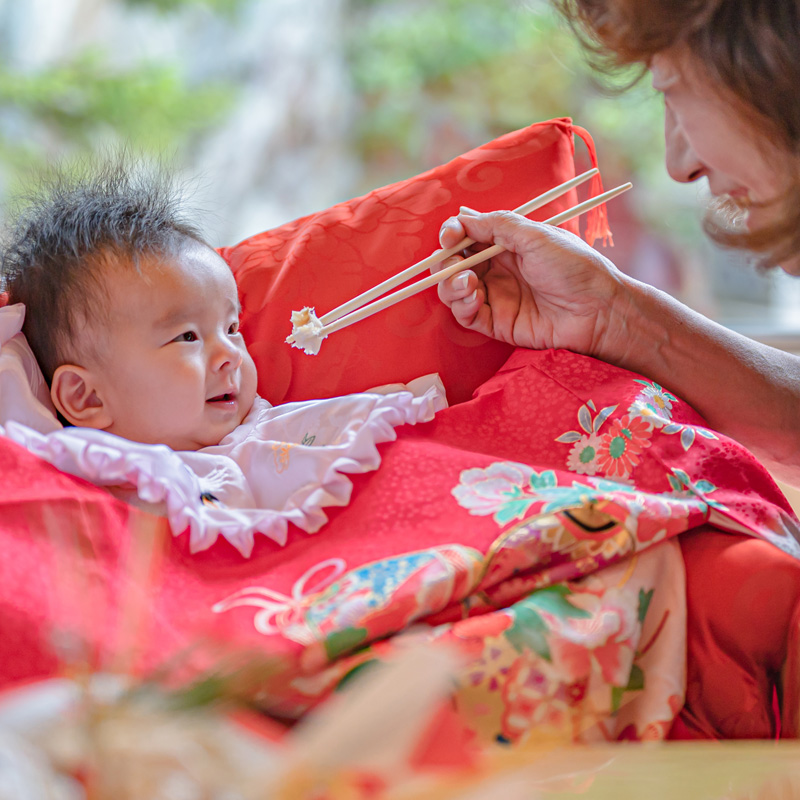 お食い初めで食べるまねをする赤ちゃん