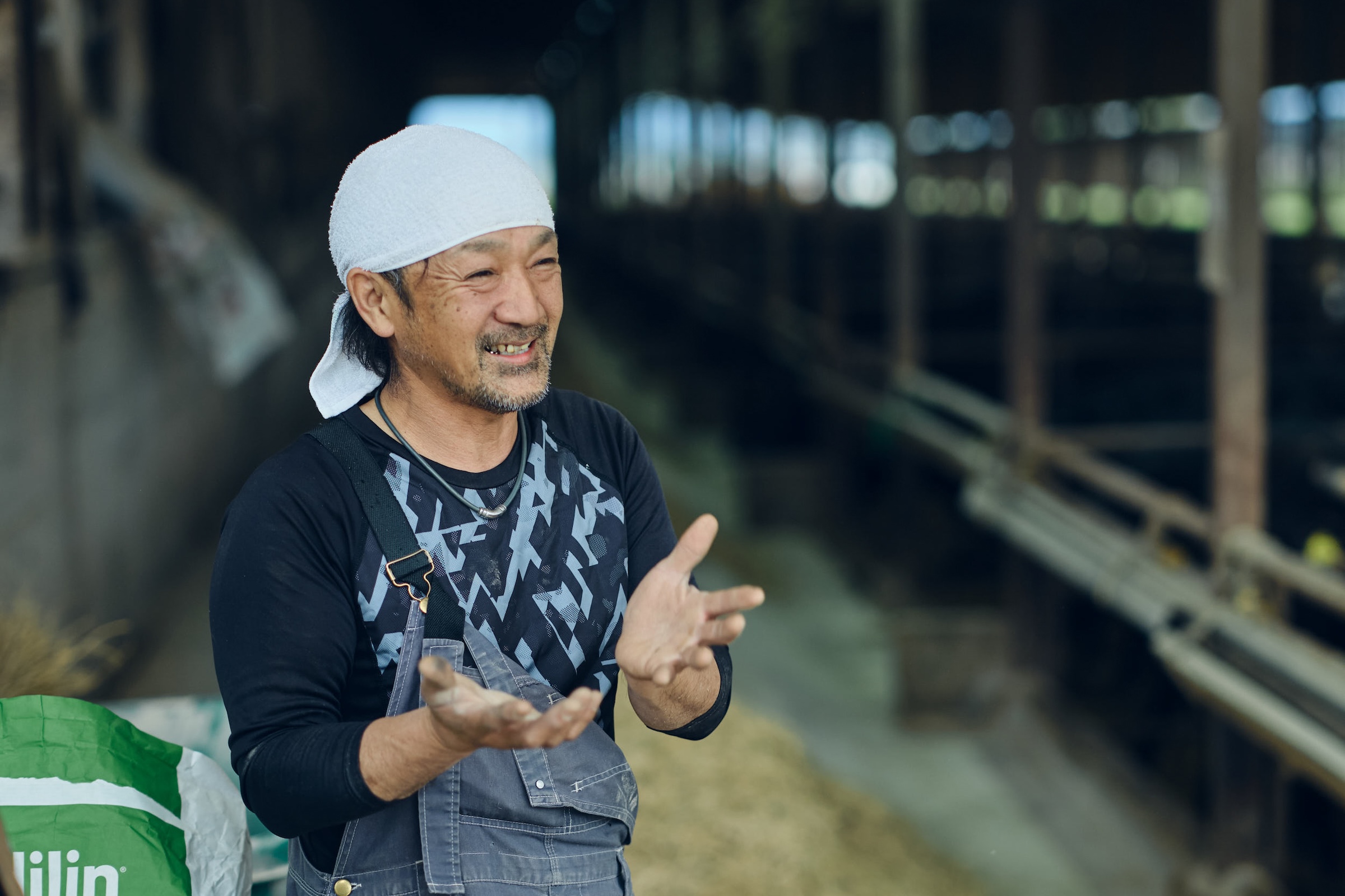 牛舎で話す、Saigo代表の増永優樹さん